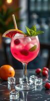 Refreshing tropical cocktail with fruits and mint served in a stylish glass on a marble table photo
