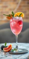 Colorful cocktail garnished with fresh fruit sits on a marble table in a stylish bar setting photo