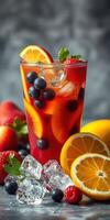 Refreshing summer beverage with vibrant fruits and ice served in a tall glass photo