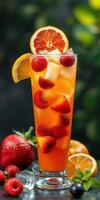 Refreshing fruit cocktail with vibrant colors served in a tall glass on a dark background photo