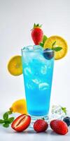 Refreshing blue cocktail garnished with strawberries, lemon, and mint on a white background photo