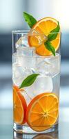 Refreshing citrus drink with ice and basil served in a clear glass during bright daylight photo