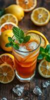Refreshing iced tea with lemon and mint garnished on a wooden table surrounded by fresh lemons photo