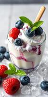 Refreshing dessert featuring blueberries and strawberries in a glass with mint leaves on a summer day photo
