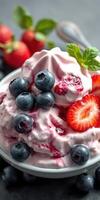 Delicious dessert bowl filled with whipped cream, berries and strawberries on a dark background photo