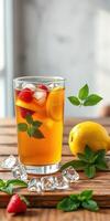 Refreshing summer beverage with lemon, strawberries, and mint served in a glass on a wooden table photo