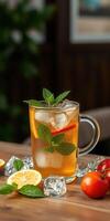 Refreshing iced tea with mint and lemon served in a glass on a wooden table with fresh ingredients photo