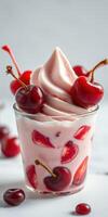 Delicious cherry and strawberry swirl dessert served in a clear cup topped with fresh fruit and whipped cream photo