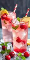 Refreshing cherry lemonade served in glasses with mint and lemon slices photo