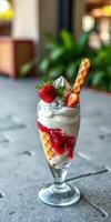 Delicious ice cream sundae topped with fresh strawberries and whipped cream at a cozy cafe photo