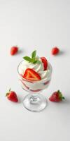 Delicious layered dessert with strawberries and whipped cream showcased on a clean surface photo