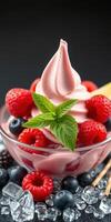 Creamy dessert topped with fresh berries and mint served in a glass bowl on a dark background photo
