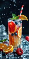 Refreshing summer drink with assorted fruits and ice on a dark background photo