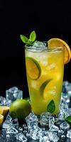 Refreshing citrus beverage garnished with mint and lime on a dark background with ice cubes photo