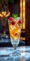 Refreshing cocktail garnished with mint and raspberries served in elegant glass at a cozy bar during evening hours photo