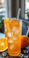 Refreshing citrus drinks with ice and orange slices served at a cozy cafe during midday photo