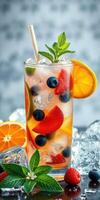 Refreshing summer cocktail with mixed fruits and mint served on a wooden table photo
