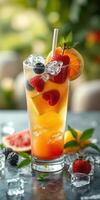 Refreshing summer drink featuring a colorful mix of fruits and ice served in a tall glass with a straw photo
