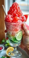 Refreshing summer dessert made with crushed ice, watermelon, and cucumbers served in a glass photo