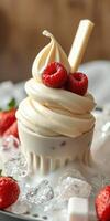 Creamy soft serve topped with fresh raspberries and accented by crushed ice and strawberries photo
