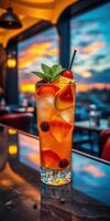 Colorful cocktail garnished with fruits and mint against a sunset backdrop in a rooftop bar setting photo