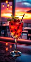 Sunset cocktail garnished with fruit and mint served in a stylish glass at a seaside bar photo