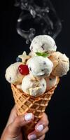 Delicious ice cream cone with multiple scoops and toppings served in a dark setting photo