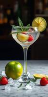 Refreshing cocktail garnished with mint, lime, and strawberries on a bar countertop during the evening photo