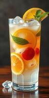 Refreshing citrus drink garnished with mint and fruit on a wooden surface photo