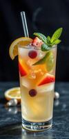 Refreshing summer cocktail with fresh fruits and mint on a dark background photo