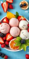 Colorful ice cream bowl filled with strawberries, blackberries, and citrus fruits for a refreshing dessert photo