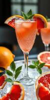 Refreshing grapefruit cocktail served in a crystal glass with mint and citrus garnishes photo