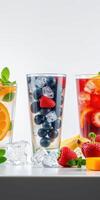 Refreshing fruit beverages with ice, vibrant colors, and fresh ingredients at a summer gathering photo