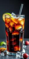 Refreshing dark beverage with ice and citrus garnishes in a tall glass on a dark background photo