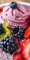 Berry ice cream dessert with fresh strawberries and blackberries on a vibrant plate photo