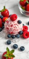 Delicious scoop of raspberry and strawberry ice cream garnished with fresh berries on a marble surface photo