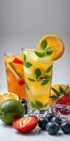 Refreshing summer cocktails with fresh fruits and herbs served in clear glasses photo