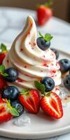 Soft serve ice cream topped with fresh strawberries and blueberries served on a plate photo