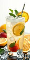 Refreshing citrus beverage with ice, mint, and vibrant fruits in clear glass on countertop photo
