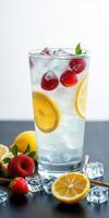 Refreshing summer beverage with strawberries and lemons served in a clear glass on a dark background photo