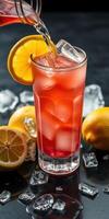 Refreshing drink being poured into a tall glass with ice and lemon at a stylish bar setting in evening light photo