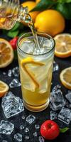 Refreshing citrus drink being poured over ice with lemon and strawberries in a vibrant kitchen setting photo