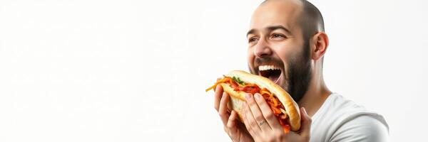 Man joyfully enjoying a large sandwich with a big smile while sitting against a white background photo