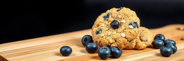 Cookies with blueberries and oats arranged on a wooden board showcasing a delicious treat photo