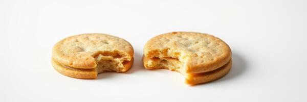 Crunchy cookies with creamy filling broken apart on a clean surface during a bright afternoon snack time photo