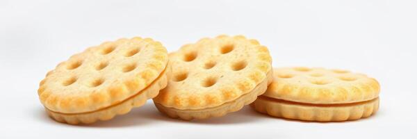 Delicious round cookies with cream filling stacked on a white background in a simple setting photo
