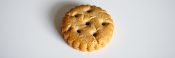 Unique round biscuit with a textured surface resting on a plain background photo
