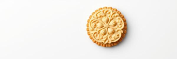Delicate round cookie with intricate design on a plain background, perfect for tea or dessert time photo
