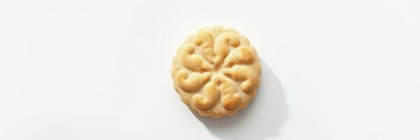 Traditional cookie with intricate design on a clean surface showcasing its details and texture photo