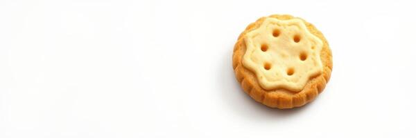 Delicious cookie with cream filling sits on a plain white surface, inviting a quick snack at any time of day photo